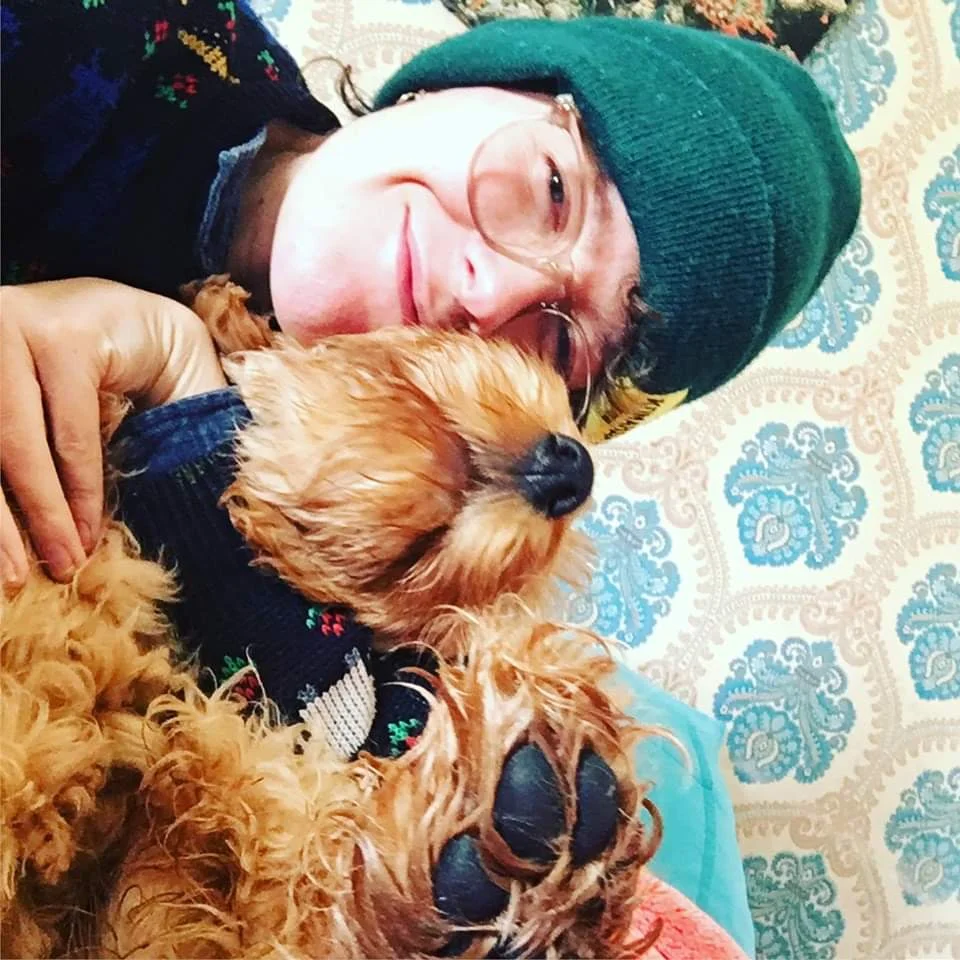 Chi Chi cuddling a client dog